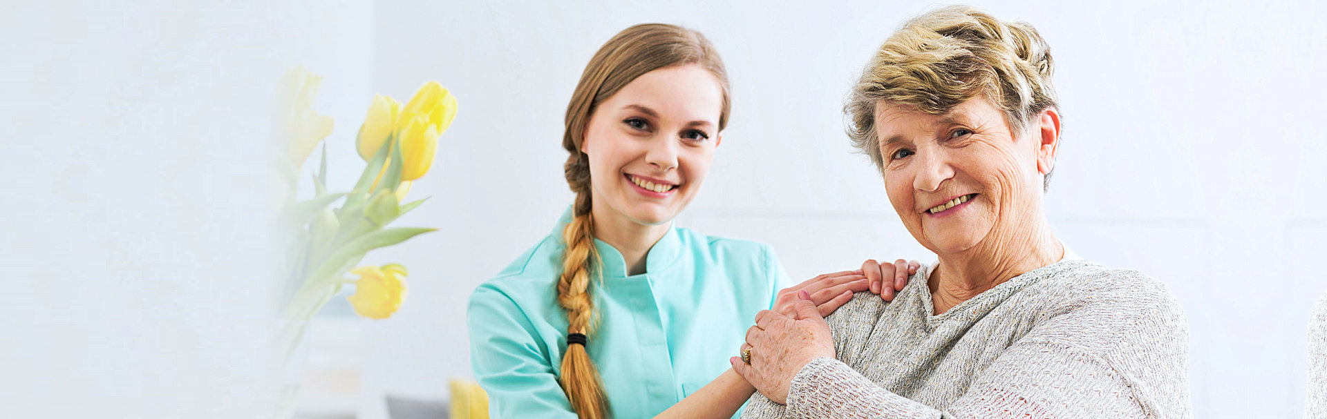 senior woman and caregiver smiling