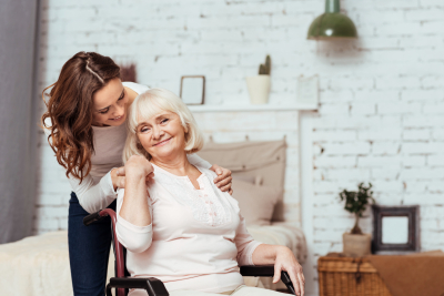 beautiful caregiver and senior woman are smiling