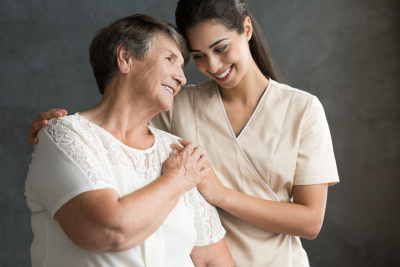 caregiver and senior woman are smiling